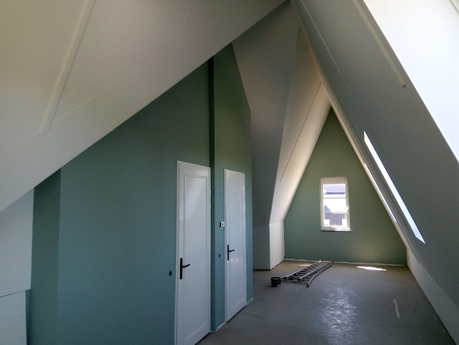 Dezelfde zolder met strak witte plafondplaten en groene wanden